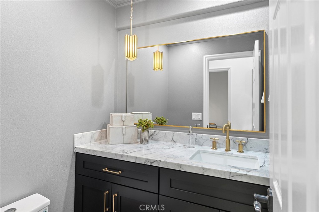 16 Meryton Irvine, CA 92603 - Photo 18 of 54 a bathroom with a granite countertop sink and a mirror