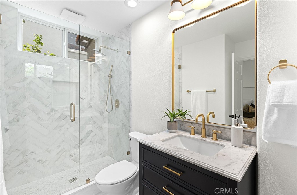 16 Meryton Irvine, CA 92603 - Photo 20 of 54 a bathroom with a granite countertop sink a toilet a mirror and shower