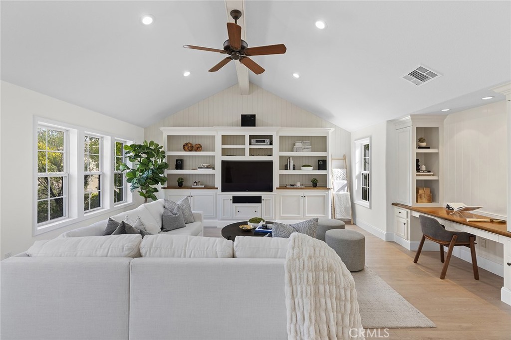 16 Meryton Irvine, CA 92603 - Photo 27 of 54 a living room with furniture a ceiling fan and a flat screen tv