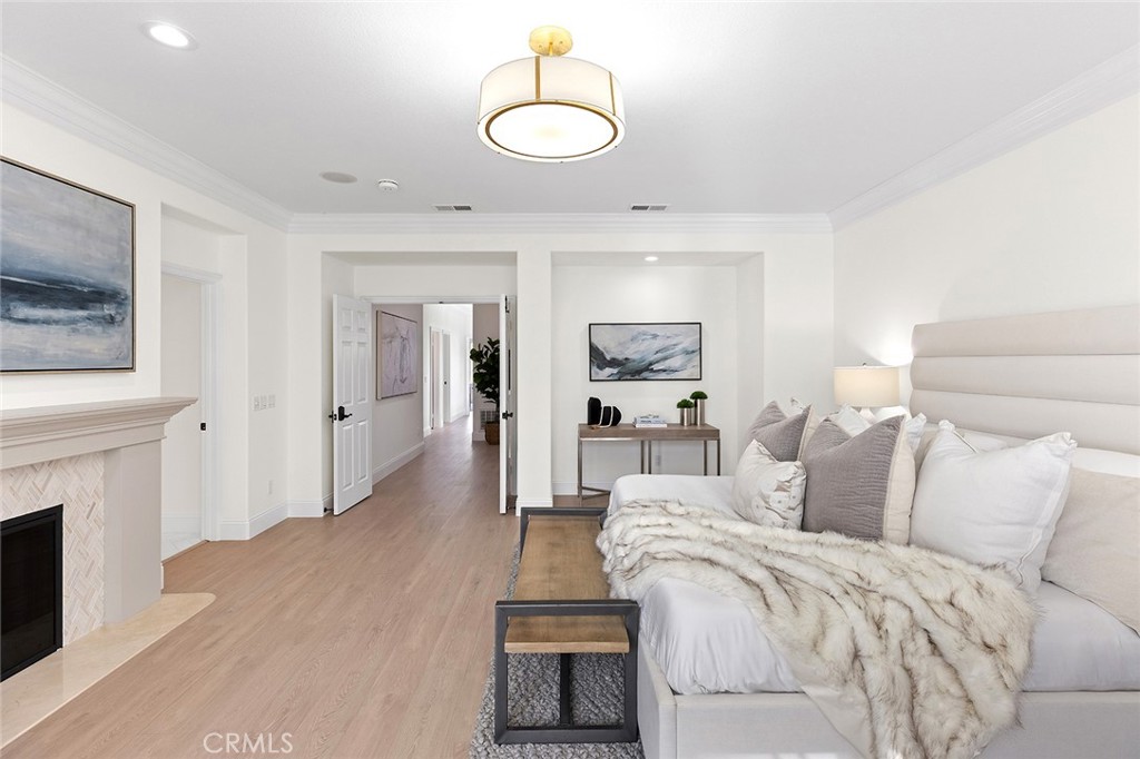 16 Meryton Irvine, CA 92603 - Photo 34 of 54 a spacious bedroom with a bed and a fireplace