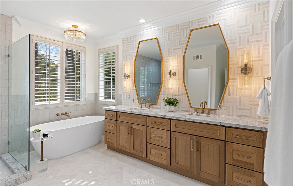 16 Meryton Irvine, CA 92603 - Photo 35 of 54 a bathroom with a double vanity sink bathtub and next to a window
