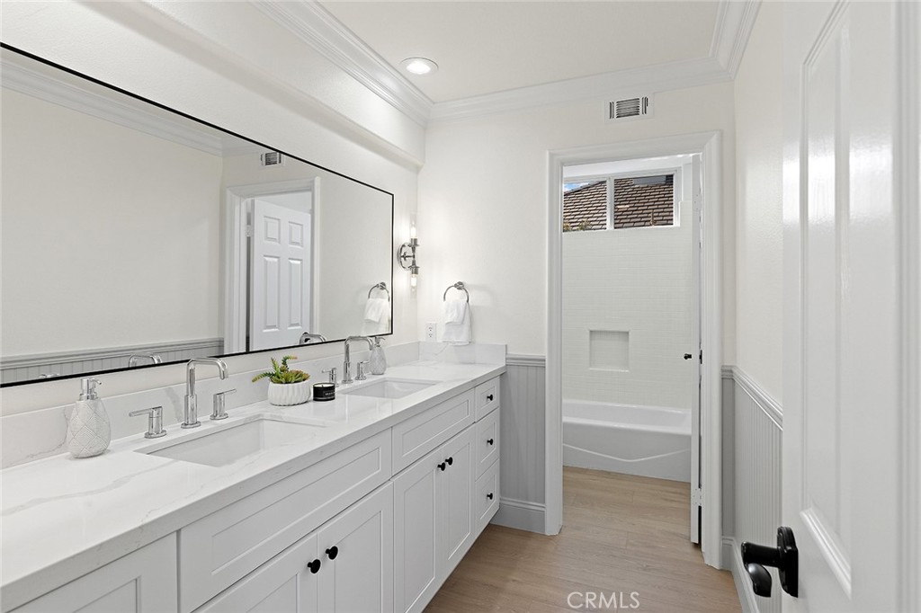 16 Meryton Irvine, CA 92603 - Photo 39 of 54 a spacious bathroom with a granite countertop sink and a mirror