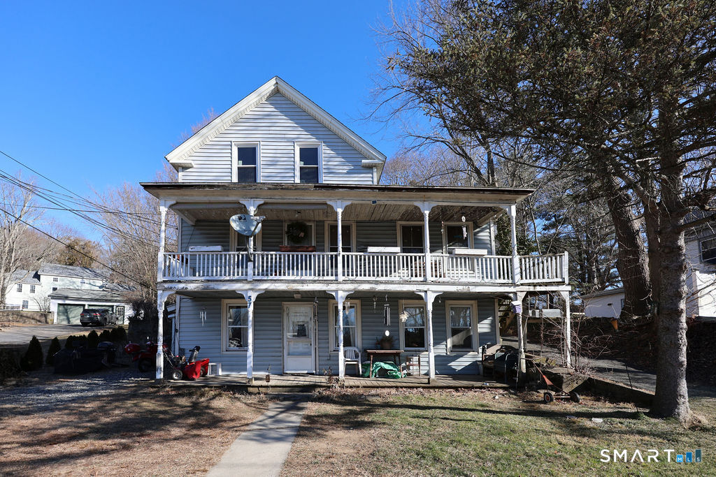 a front view of a house with sitting area