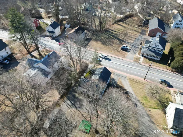an aerial view of a house with a yard