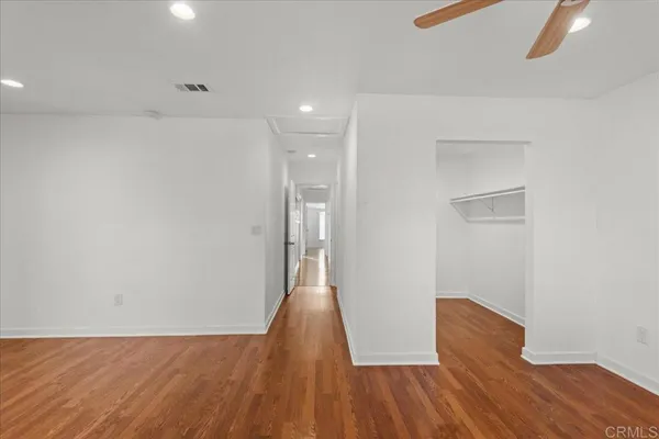 a view of a room with wooden floor