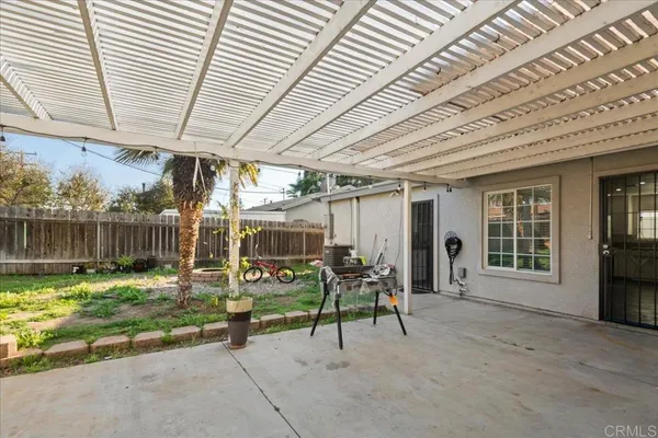 a view of a porch with furniture and next to a yard