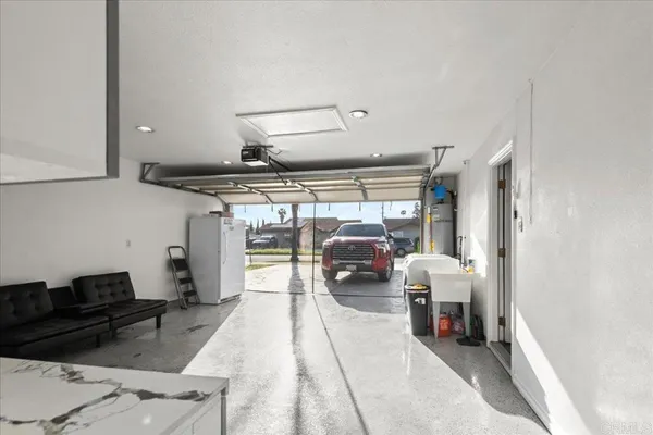 an aerial view of residential house with an outdoor space and seating