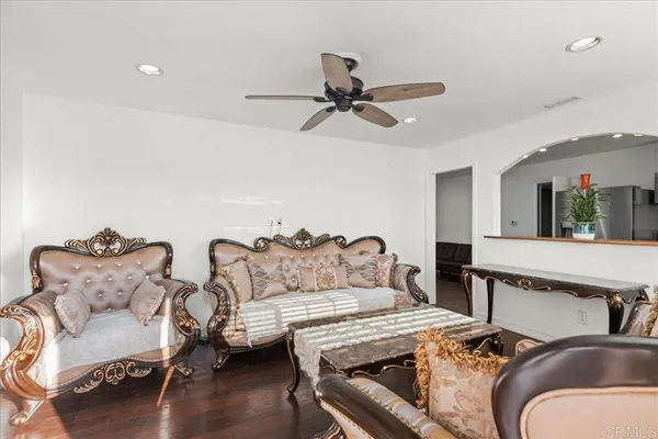 a living room with furniture and wooden floor