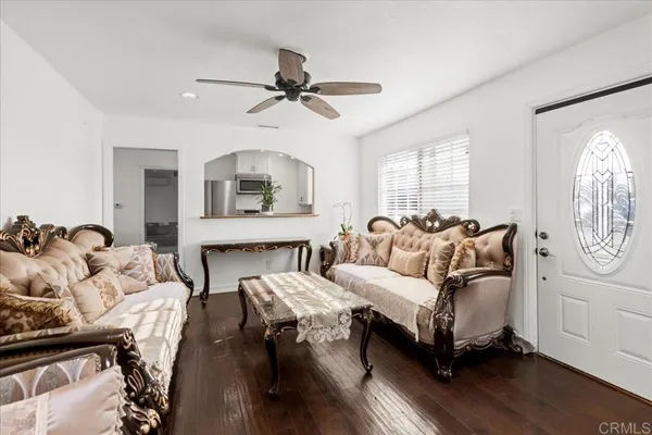 a living room with furniture a fireplace and a window