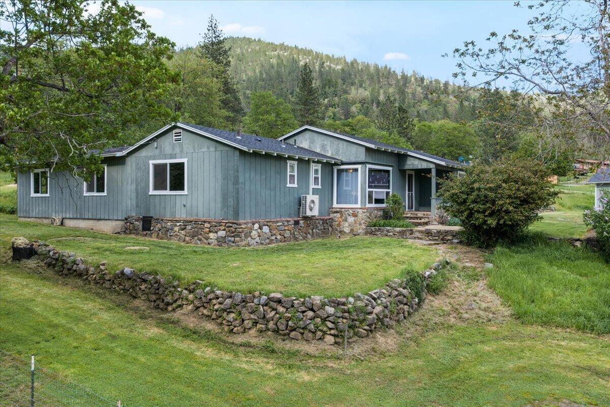 1360 Oxyoke Road Grants Pass, OR 97526 - Photo 3 of 39 a front view of a house with a garden