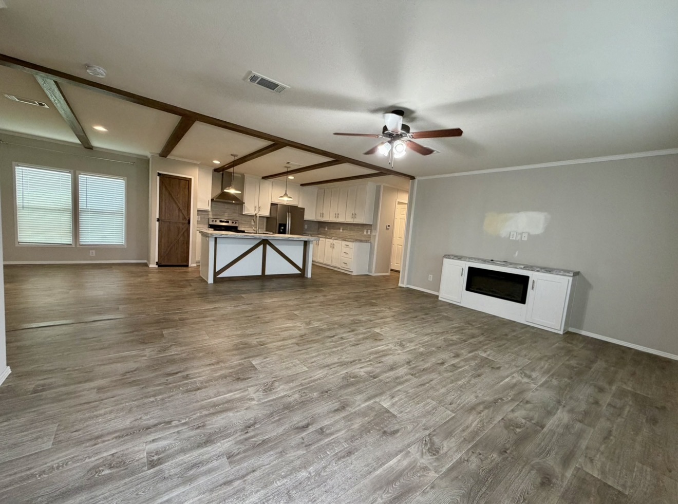 126 Castellana Way Elgin, TX 78621 - Photo 7 of 19 a view of an empty room with window and wooden floor