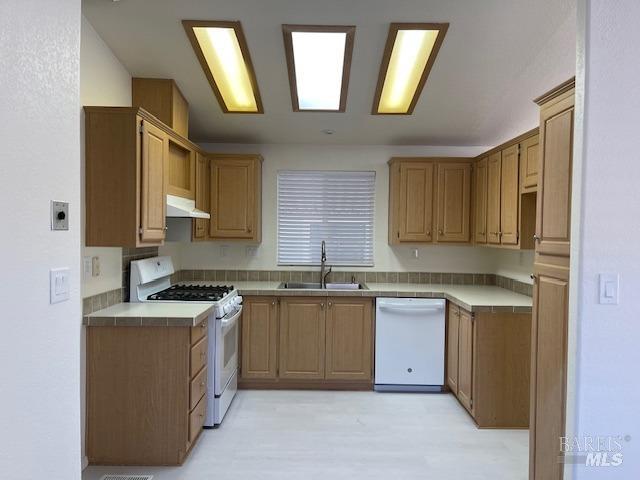 8156 D Street Windsor, CA 95492 - Photo 10 of 16 Remodeled kitchen with new flooring, new gas range/oven, hood, dishwasher, and new stainless steel sink with commercial grade faucet/wand.