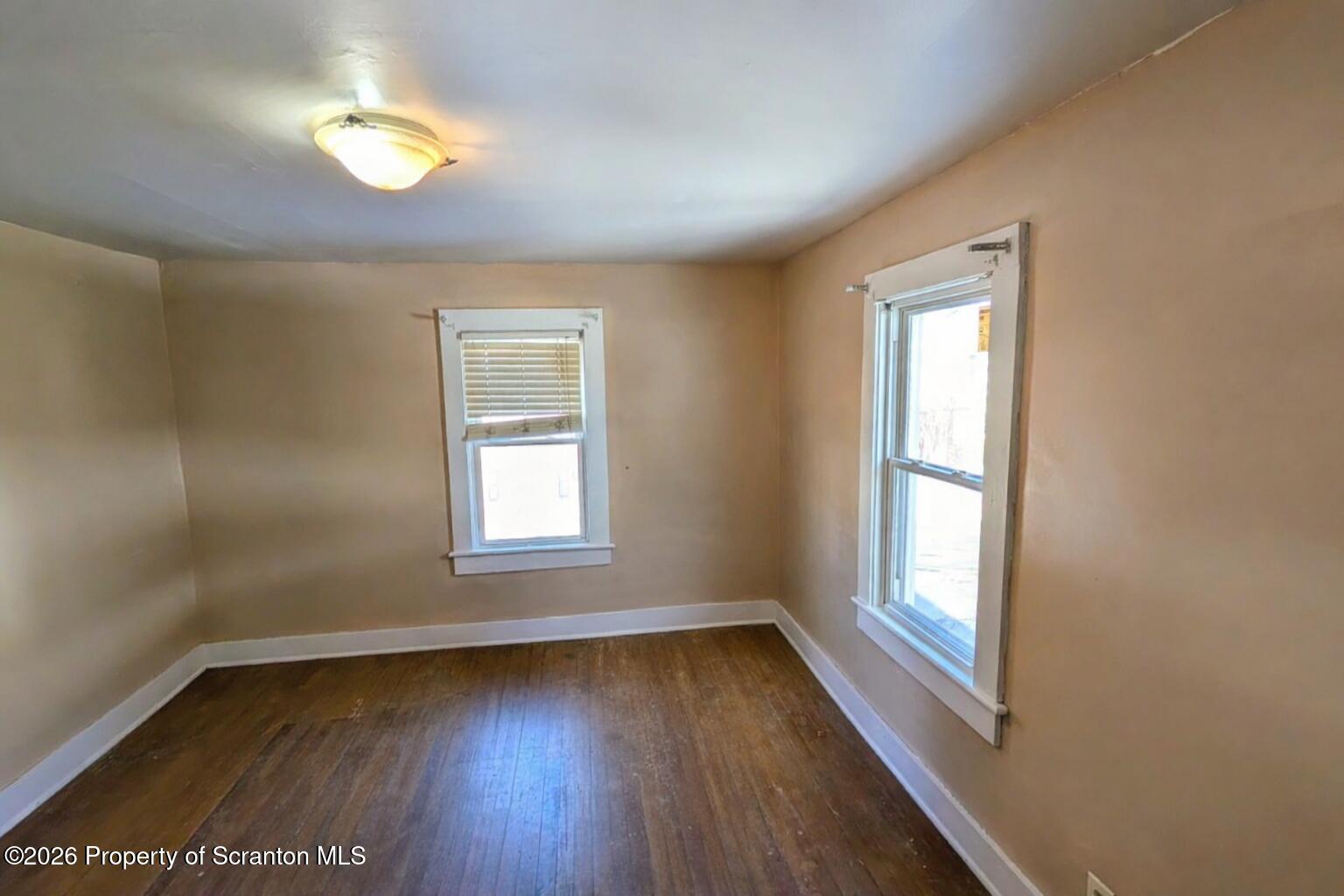 509 Main Street Duryea, PA 18642 - Photo 19 of 30 an empty room with wooden floor and windows