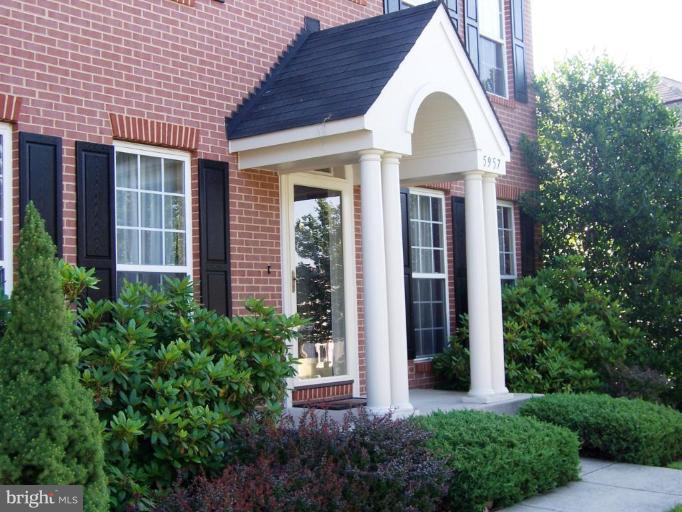 5957 Sandy Ridge Elkridge, MD 21075 - Photo 2 of 30 a front view of a house with garden