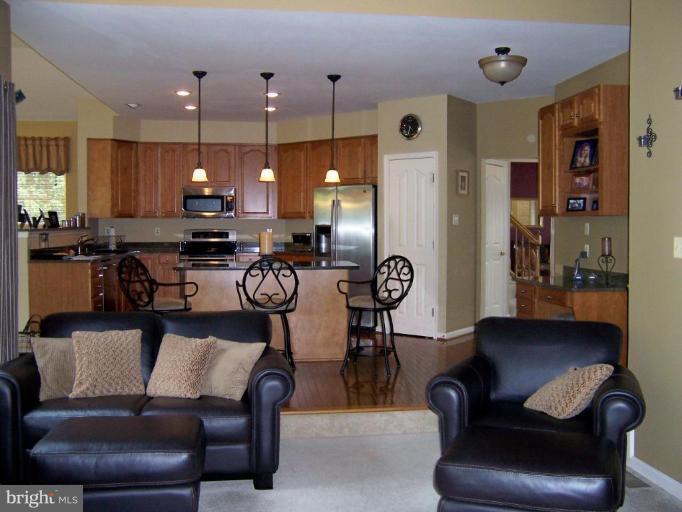 5957 Sandy Ridge Elkridge, MD 21075 - Photo 11 of 30 a view of kitchen with stainless steel appliances dining table and chairs