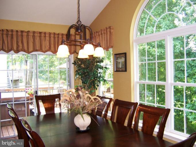 5957 Sandy Ridge Elkridge, MD 21075 - Photo 14 of 30 a view of a dining room with furniture window and wooden floor