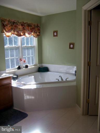 5957 Sandy Ridge Elkridge, MD 21075 - Photo 18 of 30 a view of a bath tub sitting in a bathroom