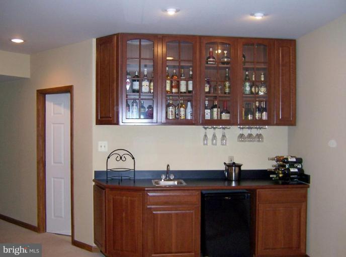 5957 Sandy Ridge Elkridge, MD 21075 - Photo 22 of 30 a kitchen with stainless steel appliances granite countertop a sink and cabinets