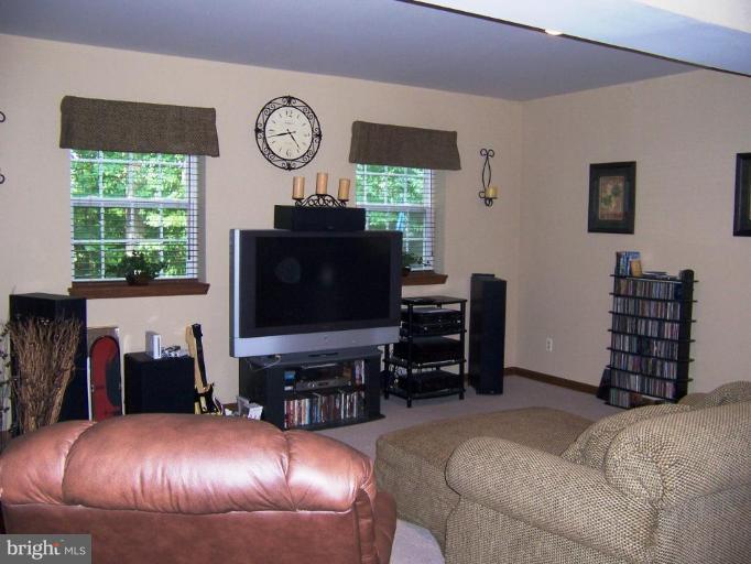 5957 Sandy Ridge Elkridge, MD 21075 - Photo 24 of 30 a living room with furniture and a flat screen tv