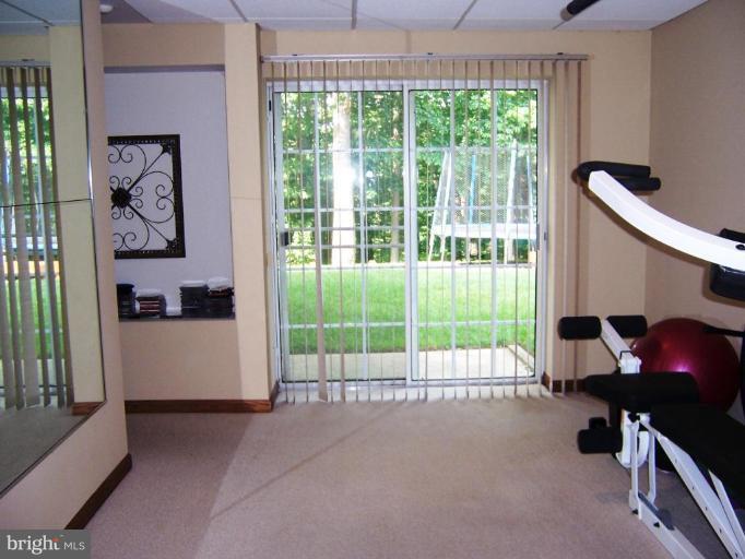 5957 Sandy Ridge Elkridge, MD 21075 - Photo 25 of 30 a view of a room with gym equipment and a large window