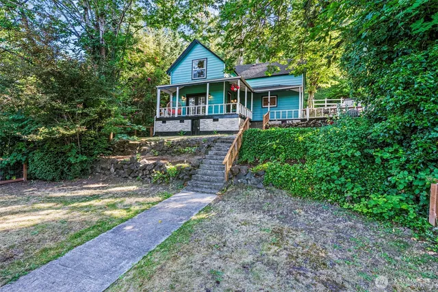 a front view of a house with yard and green space