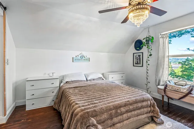 a bed room with a bed and a chandelier