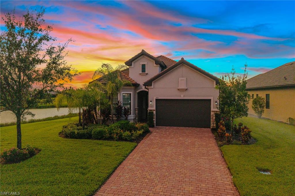 2703 Aviamar Circle Naples, FL 34114 - Photo 1 of 49 a front view of a house with garden
