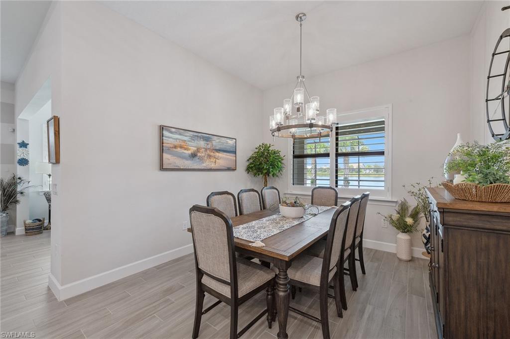 2703 Aviamar Circle Naples, FL 34114 - Photo 14 of 49 a view of a dining room with furniture window and wooden floor