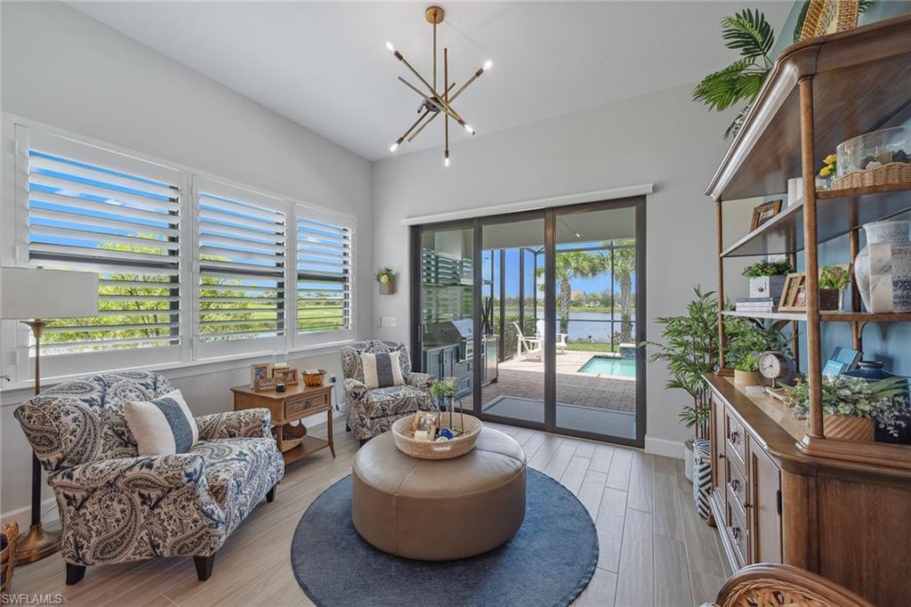 2703 Aviamar Circle Naples, FL 34114 - Photo 15 of 49 a living room with furniture and a large window