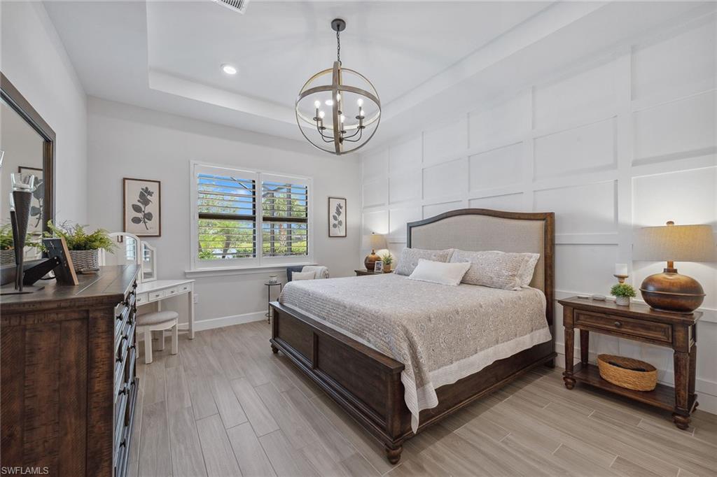 2703 Aviamar Circle Naples, FL 34114 - Photo 16 of 49 a bedroom with a bed and a table in it