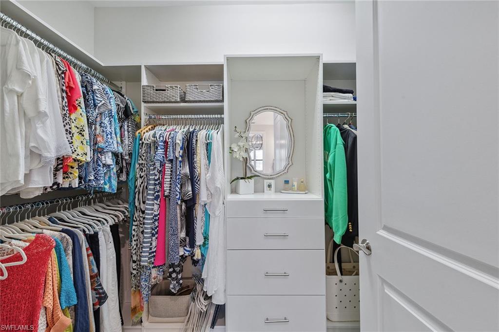 2703 Aviamar Circle Naples, FL 34114 - Photo 21 of 49 a view of walk in closet with clothes