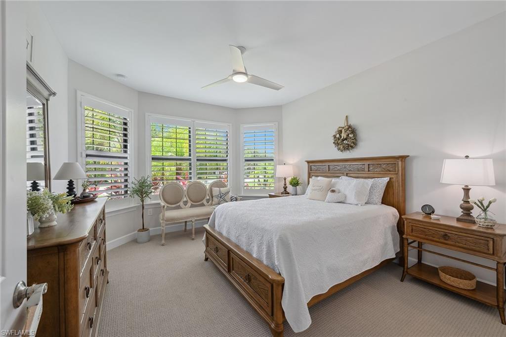 2703 Aviamar Circle Naples, FL 34114 - Photo 22 of 49 a bedroom with a bed and large windows