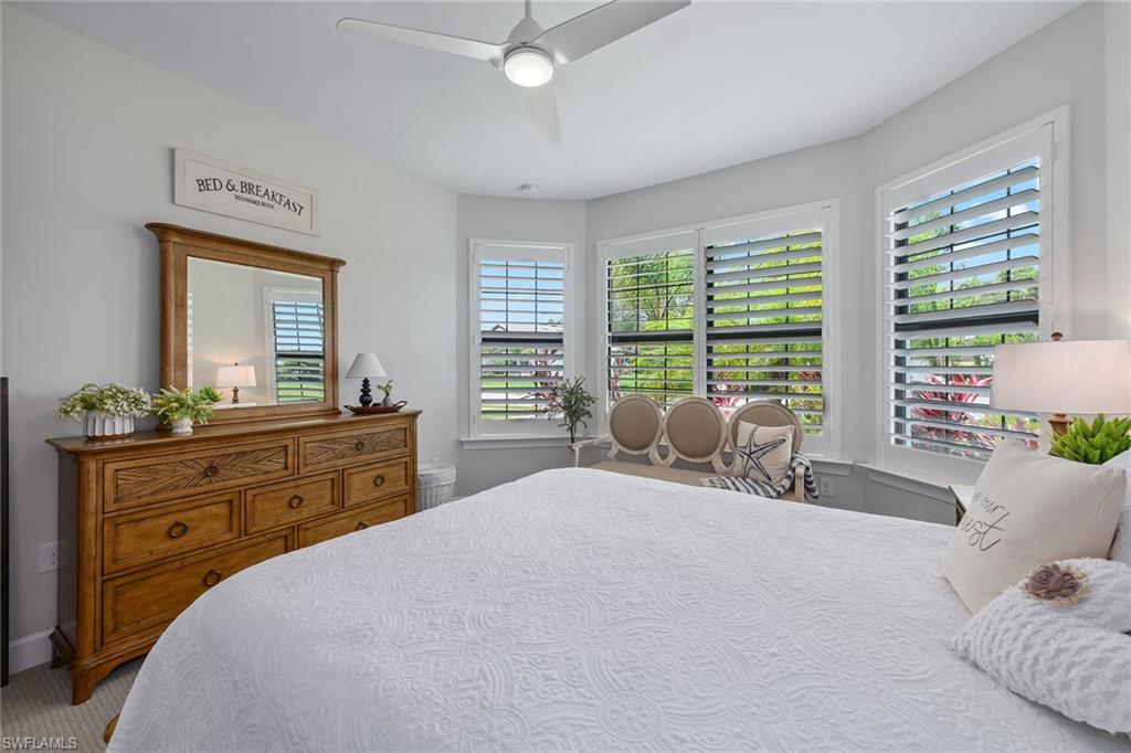 2703 Aviamar Circle Naples, FL 34114 - Photo 23 of 49 a bedroom with a large bed and a window