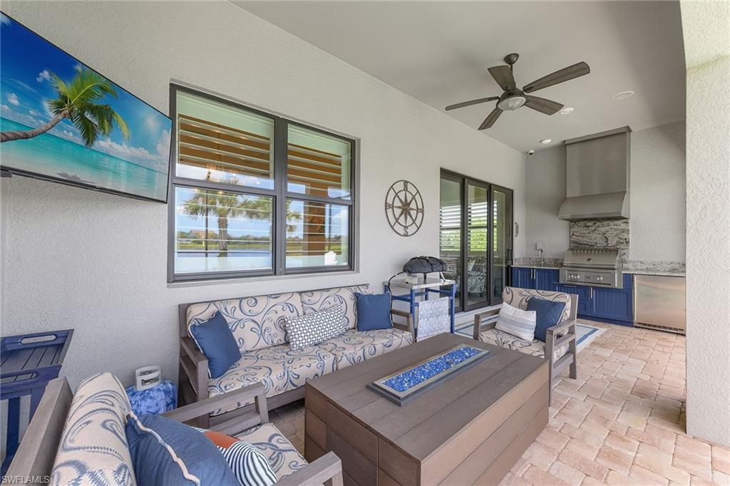 2703 Aviamar Circle Naples, FL 34114 - Photo 27 of 49 a living room with furniture and a large window