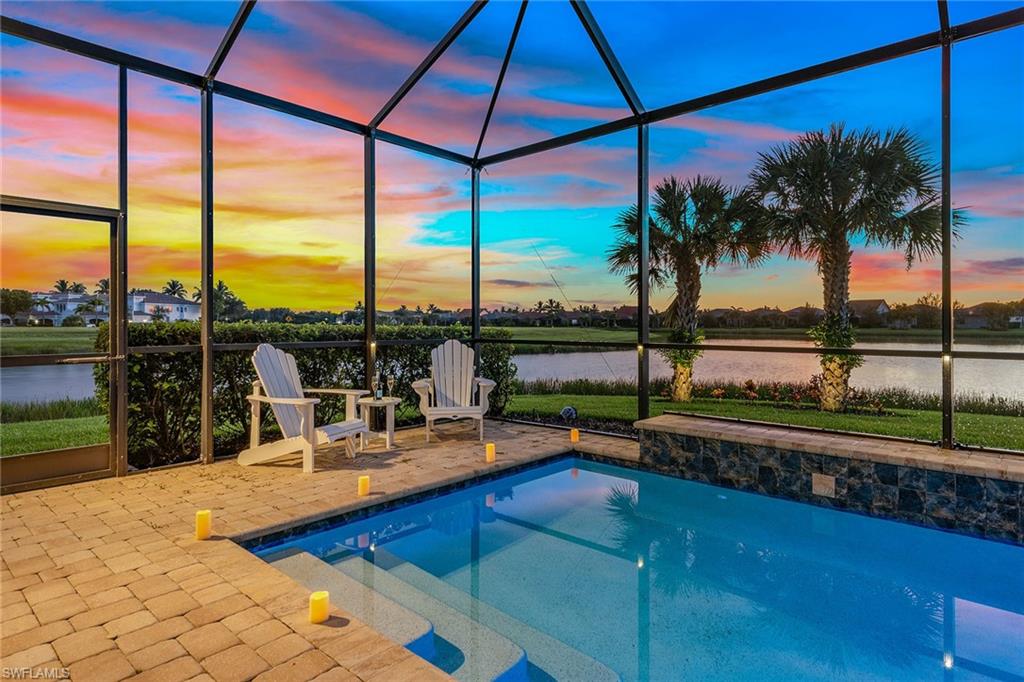 2703 Aviamar Circle Naples, FL 34114 - Photo 30 of 49 a view of swimming pool with a table and chairs