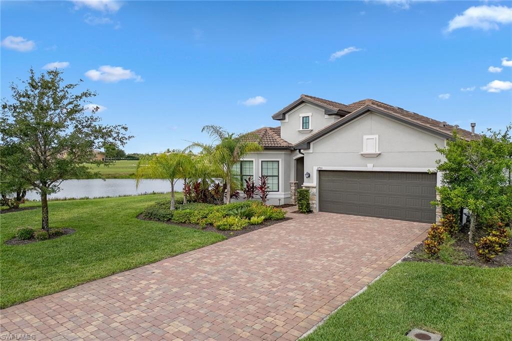 2703 Aviamar Circle Naples, FL 34114 - Photo 33 of 49 a front view of a house with a yard and garage
