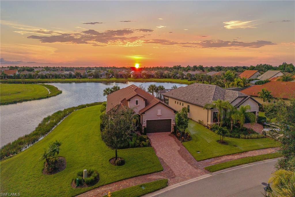 2703 Aviamar Circle Naples, FL 34114 - Photo 34 of 49 an aerial view of a house with a garden and lake view