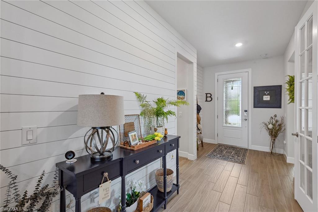 2703 Aviamar Circle Naples, FL 34114 - Photo 5 of 49 a view of a workspace with furniture and wooden floor
