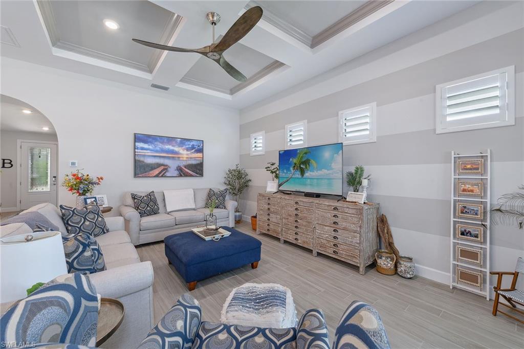 2703 Aviamar Circle Naples, FL 34114 - Photo 6 of 49 a living room with furniture and a flat screen tv