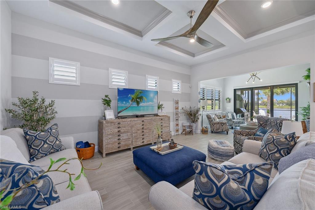 2703 Aviamar Circle Naples, FL 34114 - Photo 7 of 49 a living room with furniture and a fireplace