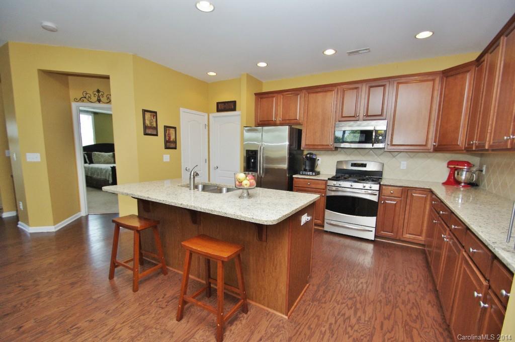 1301 Ridgehaven Road Waxhaw, NC 28173 - Photo 11 of 24 a kitchen with stainless steel appliances kitchen island granite countertop a sink and cabinets