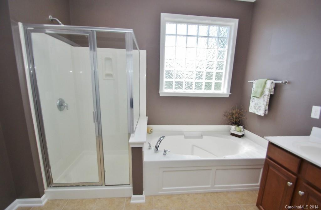 1301 Ridgehaven Road Waxhaw, NC 28173 - Photo 14 of 24 a bathroom with a bathtub and a shower