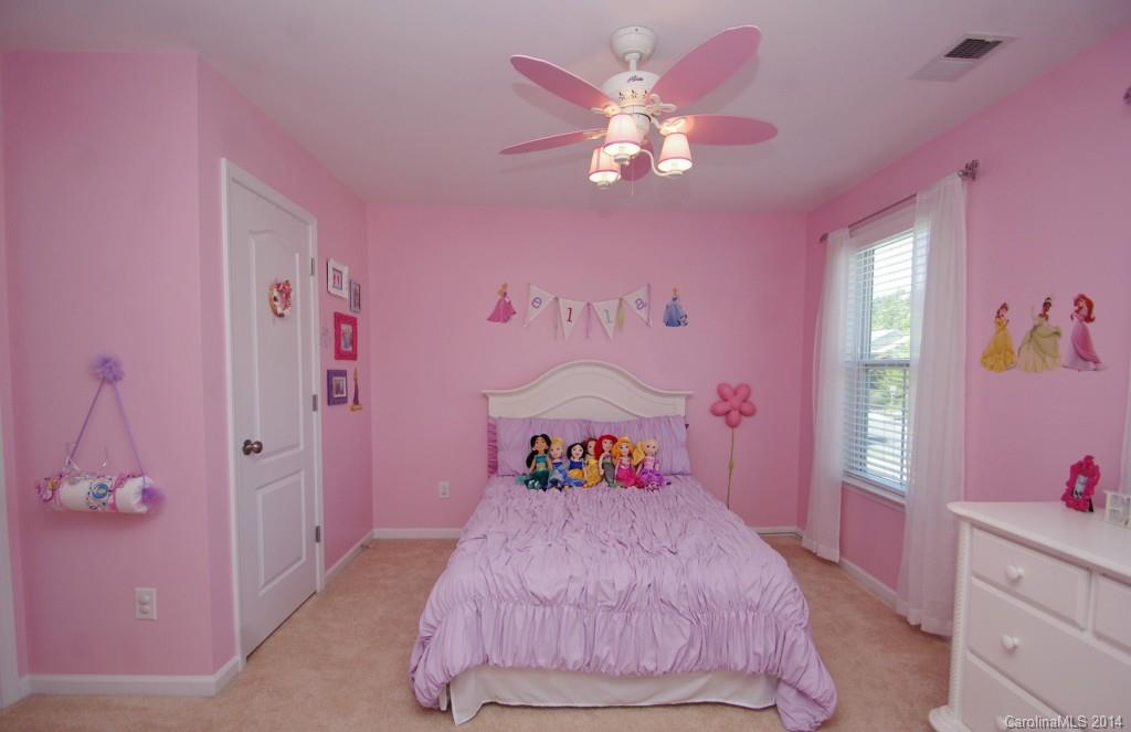 1301 Ridgehaven Road Waxhaw, NC 28173 - Photo 16 of 24 a bedroom with a bed and a chandelier