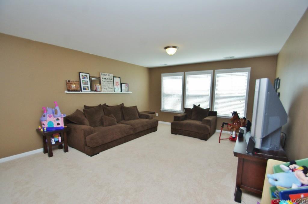 1301 Ridgehaven Road Waxhaw, NC 28173 - Photo 18 of 24 a living room with furniture large window and a flat screen tv