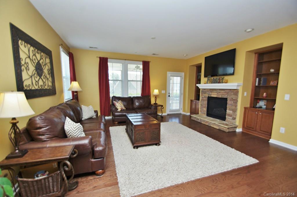 1301 Ridgehaven Road Waxhaw, NC 28173 - Photo 7 of 24 a living room with furniture a flat screen tv and a fireplace