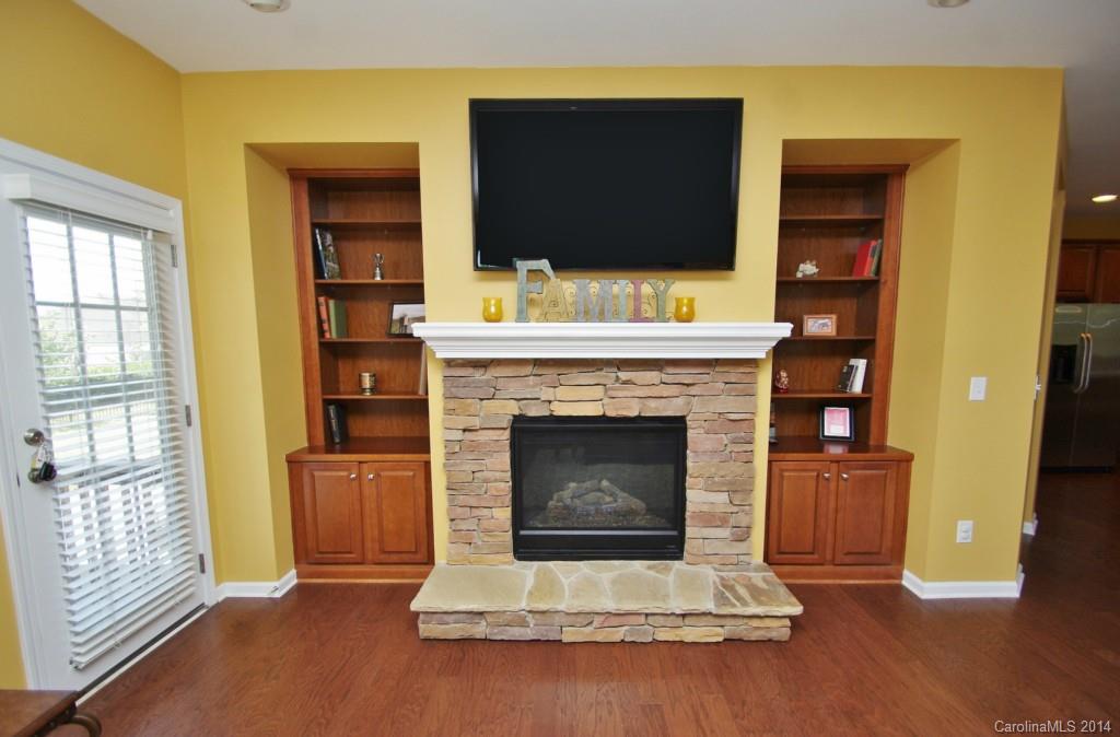 1301 Ridgehaven Road Waxhaw, NC 28173 - Photo 8 of 24 a living room with a fireplace and a flat screen tv