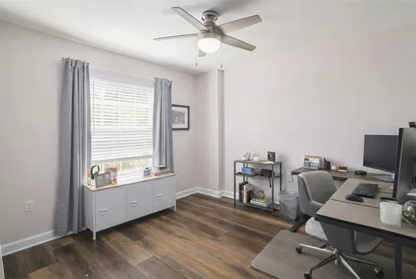 a view of a workspace with furniture and a window