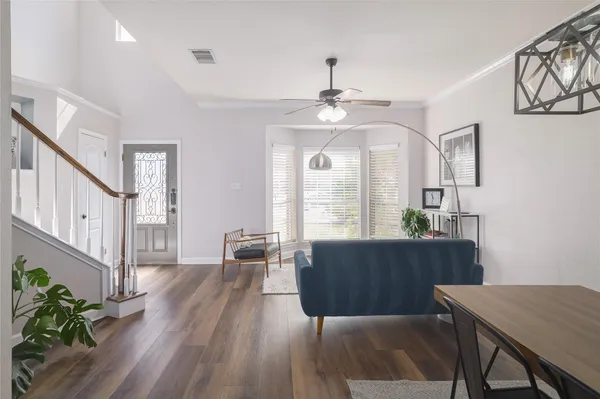 a living room with furniture and a wooden floor