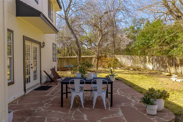 a view of a backyard with table and chairs