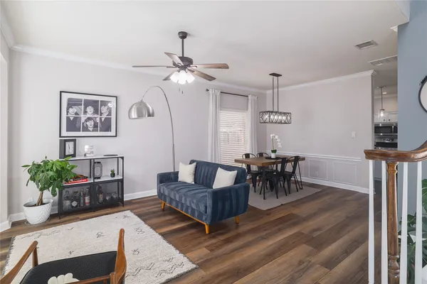 a living room with furniture and a chandelier